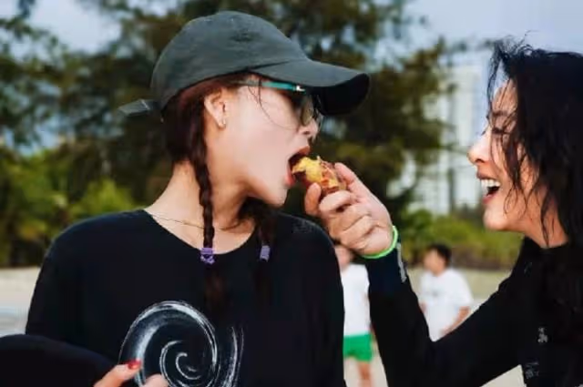 殷桃穿弔帶背心現身海灘，戴大金鍊子秀鎖骨，張嘴被人喂食太性感