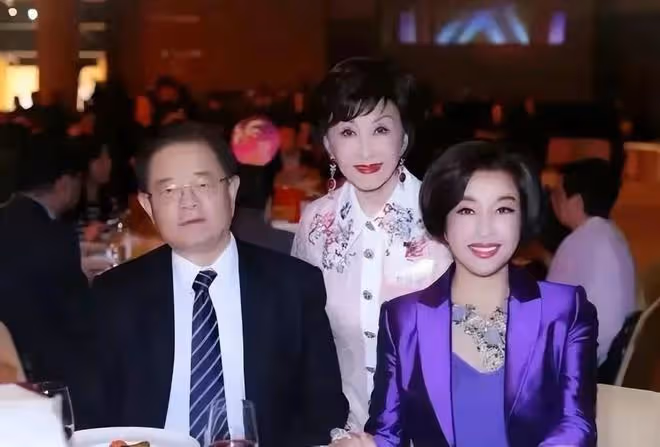劉曉慶和四婚老公出來應酬！她一襲紫色西裝比老公還氣派，太高調