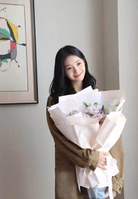 劉浩存新劇殺青照火了!風衣加持,歪頭捧花盡顯俏皮可愛