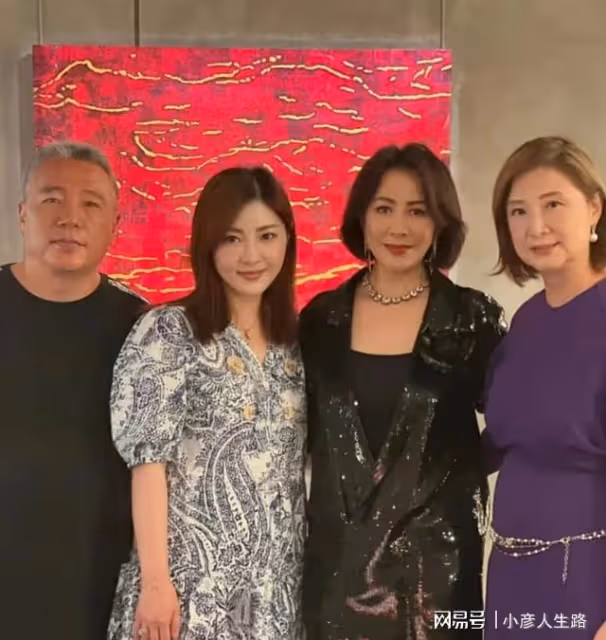 劉嘉玲參加薛松畫展，黑色西裝搭配銀色項鍊，和友人合影非常親切