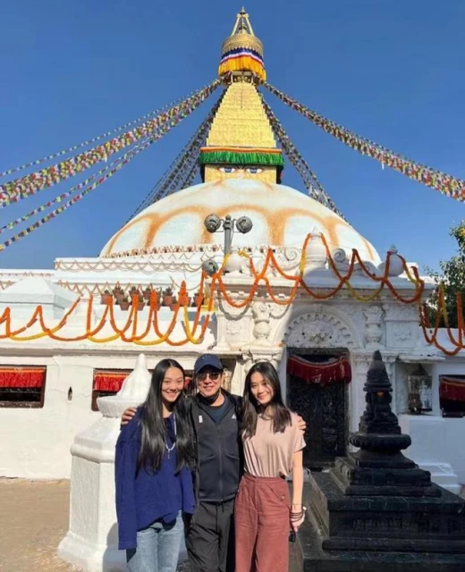 李連杰攜妻女拜訪佛學院，與倆女兒摟肩合影，步伐穩健精神好