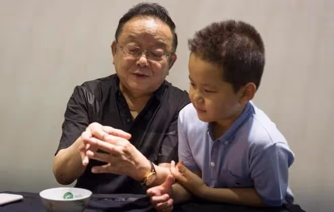 74歲王剛被傳移民後現身國內,帶兒子看球,父子五官氣質一模一樣