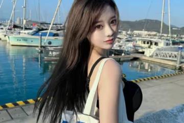 海風中的時尚精靈：黑裙美女演繹夏日簡約魅力風尚